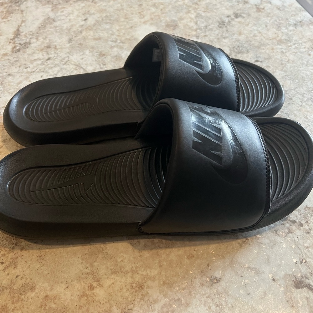 Black Nike cushion slides